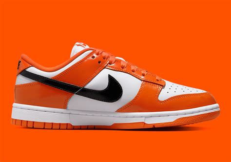 orange and black dunks low.